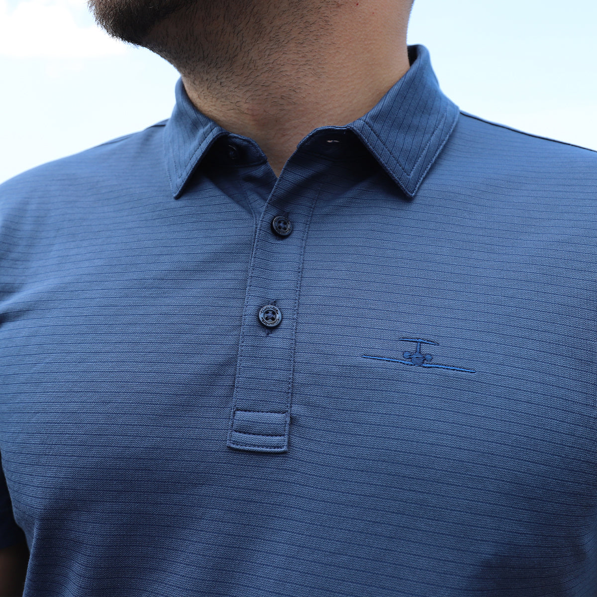 Banyan Plane Logo on Travis Mathew Polo