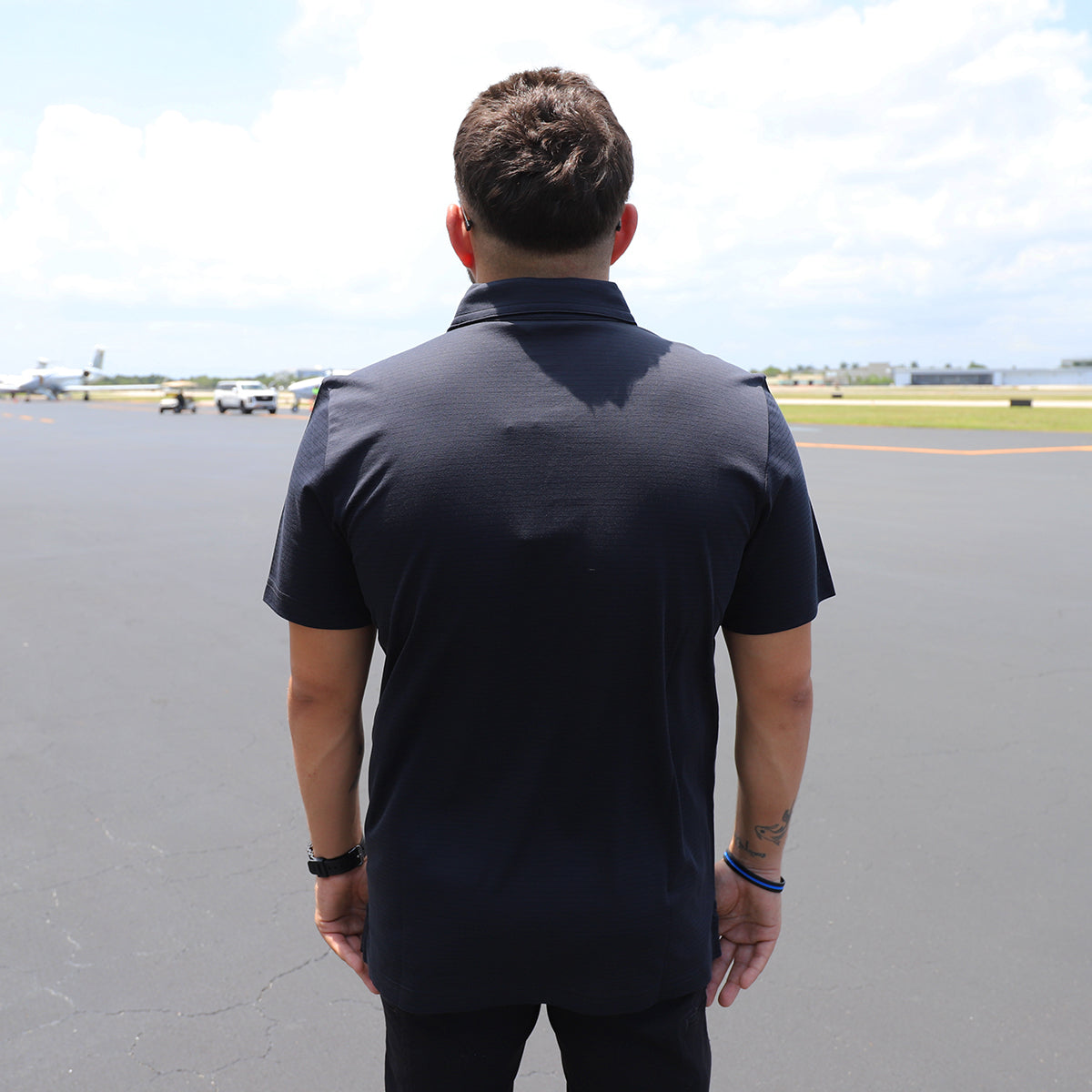 Black TravisMathew Polo With Banyan Logo